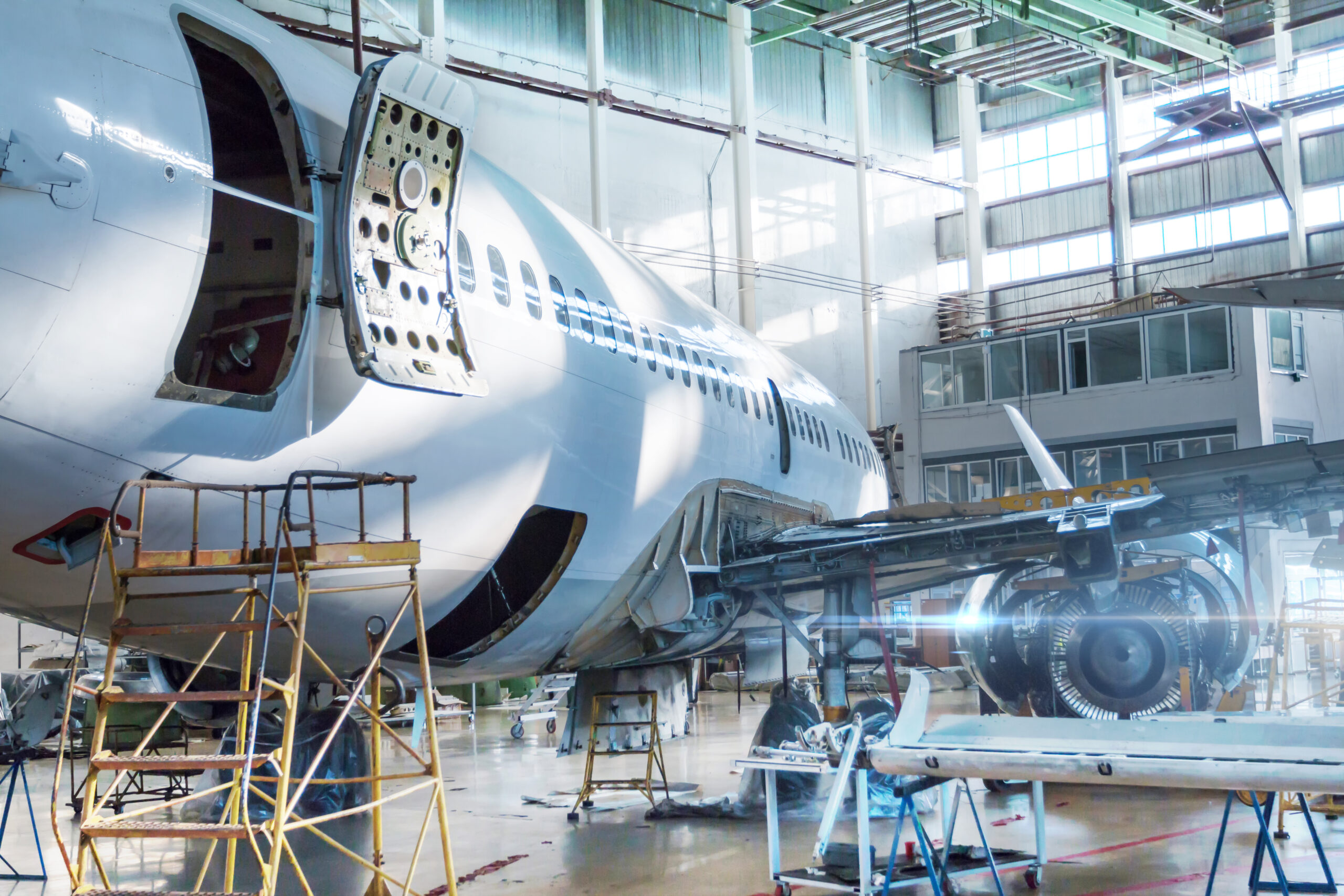 Passenger jet plane under maintenance in the hangar.
